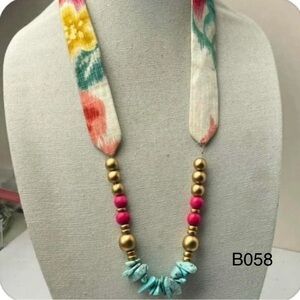 Fabric neckline and matching colorful beads dangling at center of necklace NWOT